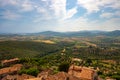 Landscape from tower of Capalbio castle, Tuscany, Italy, with fields, hills, buildings, blue sky and clouds