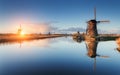 Landscape with traditional dutch windmills and path near the water canals. Royalty Free Stock Photo