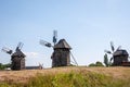 Landscape with traditional Ukrainian windmills houses in countryside village. Windmill mill at rural outdoor. Wind mill. Windmill Royalty Free Stock Photo