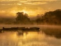 Landscape with trees and clouds reflecting in calm water