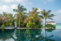 Landscape of tropical beach with infinity swimming pool and palm trees at island luxury resort Royalty Free Stock Photo
