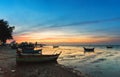 Landscape of tropical beach with old fishing boat parked on the beach in twilight sunset in Pattaya, Thailand