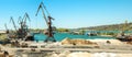 Landscape of tugboats and cranes in shipyard in coast Royalty Free Stock Photo