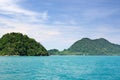 Landscape with turquoise tropical sea, dark blue sky with white clouds and tropical Koh Chang island on horizon in Thailand Royalty Free Stock Photo