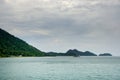 Landscape with turquoise tropical sea, monsoon storm heavy clouds and tropical Koh Chang island on horizon in Thailand Royalty Free Stock Photo