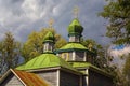 Landscape view of ancient wooden cossack church against cloudy sky. Few minutes before spring thunderstorm