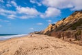 A landscape view of the beach and large cliff at Crystal Cove in Newport Coast, California