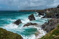 Landscape view of bedruthan steps pillars rocks , with big waves smashing up against them