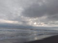 landscape view of black sand beach with dark sky covered with clouds Royalty Free Stock Photo