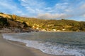 landscape view of Cavoli Beach on Elba in warm evening light and boulders in the foreground Royalty Free Stock Photo