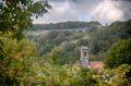 Landscape view of a church in mountains with thunderstorm clouds in background Royalty Free Stock Photo