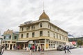 A landscape view of the classic gold rush hotel the Golden North Hotel; with tourists walking Royalty Free Stock Photo