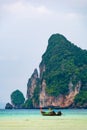 Landscape view of coastline with limestone rock and boats on ocean at Ko Phi Phi islands, Thailand. Concept of exotic tropical Royalty Free Stock Photo