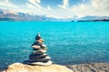 Landscape view of colorful lake Pukaki, stones pyramid and Mt Cook in distance, New Zealand Royalty Free Stock Photo