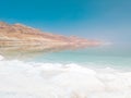 Landscape view on Dead Sea salt crystals formations, clear cyan green water and mountains at Ein Bokek beach, Israel Royalty Free Stock Photo