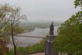 Landscape view of Dnipro River with the Pedestrian Bridge and famous Monument of Vladimir The Great during spring foggy morning