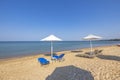 Landscape view of empty sunbeds under umbrellas on sandbeach.