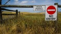 Farmland with signs at the gate Royalty Free Stock Photo