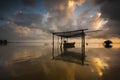 Landscape view with fiber boat near the sea during sunset. Royalty Free Stock Photo