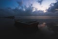 Landscape view with fiber boat near the sea during sunset. Royalty Free Stock Photo