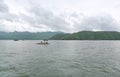 Landscape view of fishing boat in the lake with mountain at kanchanaburi, Thailand Royalty Free Stock Photo