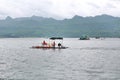 Landscape view of fishing boat in the lake with mountain at kanchanaburi, Thailand Royalty Free Stock Photo