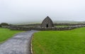 Landscape view of the Gallarus Oratory early-Christian church in County Kerry on a foggy morning