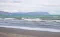 Landscape view of gentle waves rolling in on Raumati Beach, New Zealand Royalty Free Stock Photo