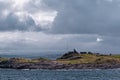 Harsh sea at Mortavika and the weather or radar station on the small hill, Norway Royalty Free Stock Photo