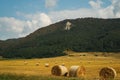 Landscape view of haycocks, fields and cypresses