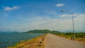 Landscape view of hills covered with trees. Surrounded by a large Prasae Reservoir. Under blue sky and white clounds. At Wang Chan Royalty Free Stock Photo