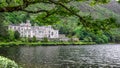 Landscape view of Kylemore Abbey and Green Victorian Walled Garden standing above blue lake. Ireland.