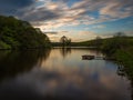 Landscape view with a lake reflectin sky and trees at sunset Royalty Free Stock Photo