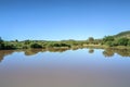 Landscape view of a lake surrounded by mountains and green savanna grassland, Pilanesburg Nature Reserve Royalty Free Stock Photo