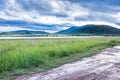 Landscape view of a lake surrounded by mountains and green savanna grassland, Pilanesburg Nature Reserve Royalty Free Stock Photo