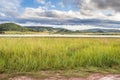 Landscape view of a lake surrounded by mountains and green savanna grassland, Pilanesburg Nature Reserve Royalty Free Stock Photo