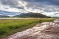 Landscape view of a lake surrounded by mountains and green savanna grassland, Pilanesburg Nature Reserve Royalty Free Stock Photo