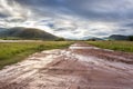 Landscape view of a lake surrounded by mountains and green savanna grassland, Pilanesburg Nature Reserve Royalty Free Stock Photo