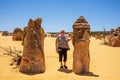 Mature woman tourist admiring the limestone pinnacles in the Nambung National Park, Cervantes, Western Australia