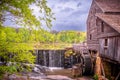 Landscape view of the millpond, waterfall, and gristmill at Historic Yates Mill County Park