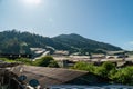 Landscape view of mountain with greenhouse roof under sunny day. Greenhouse in farmland. Sunray with greenhouse and mountain Royalty Free Stock Photo