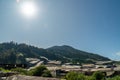 Landscape view of mountain with greenhouse roof under sunny day. Greenhouse in farmland. Sunray with greenhouse and mountain Royalty Free Stock Photo