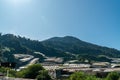 Landscape view of mountain with greenhouse roof under sunny day. Greenhouse in farmland. Sunray with greenhouse and mountain Royalty Free Stock Photo