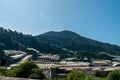 Landscape view of mountain with greenhouse roof under sunny day. Greenhouse in farmland. Sunray with greenhouse and mountain Royalty Free Stock Photo