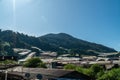 Landscape view of mountain with greenhouse roof under sunny day. Greenhouse in farmland. Sunray with greenhouse and mountain Royalty Free Stock Photo