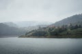 Landscape view of mountain village on Zaovine lake in fogg Royalty Free Stock Photo