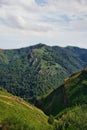 Landscape view of mountains with a forest under a cloudy sky on a sunny day in Pyrenees-Atlantiques Royalty Free Stock Photo