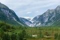 Landscape view of the Nigardsbreen melting glacier and the forest in  Norway Royalty Free Stock Photo