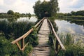 Landscape view of Old small wooden bridge across the lake. Fishman house on an island surrounded by wather and forest Royalty Free Stock Photo