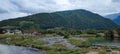 Landscape view over Lim river, with a swamp near houses, forested mountain and cloudy sky background